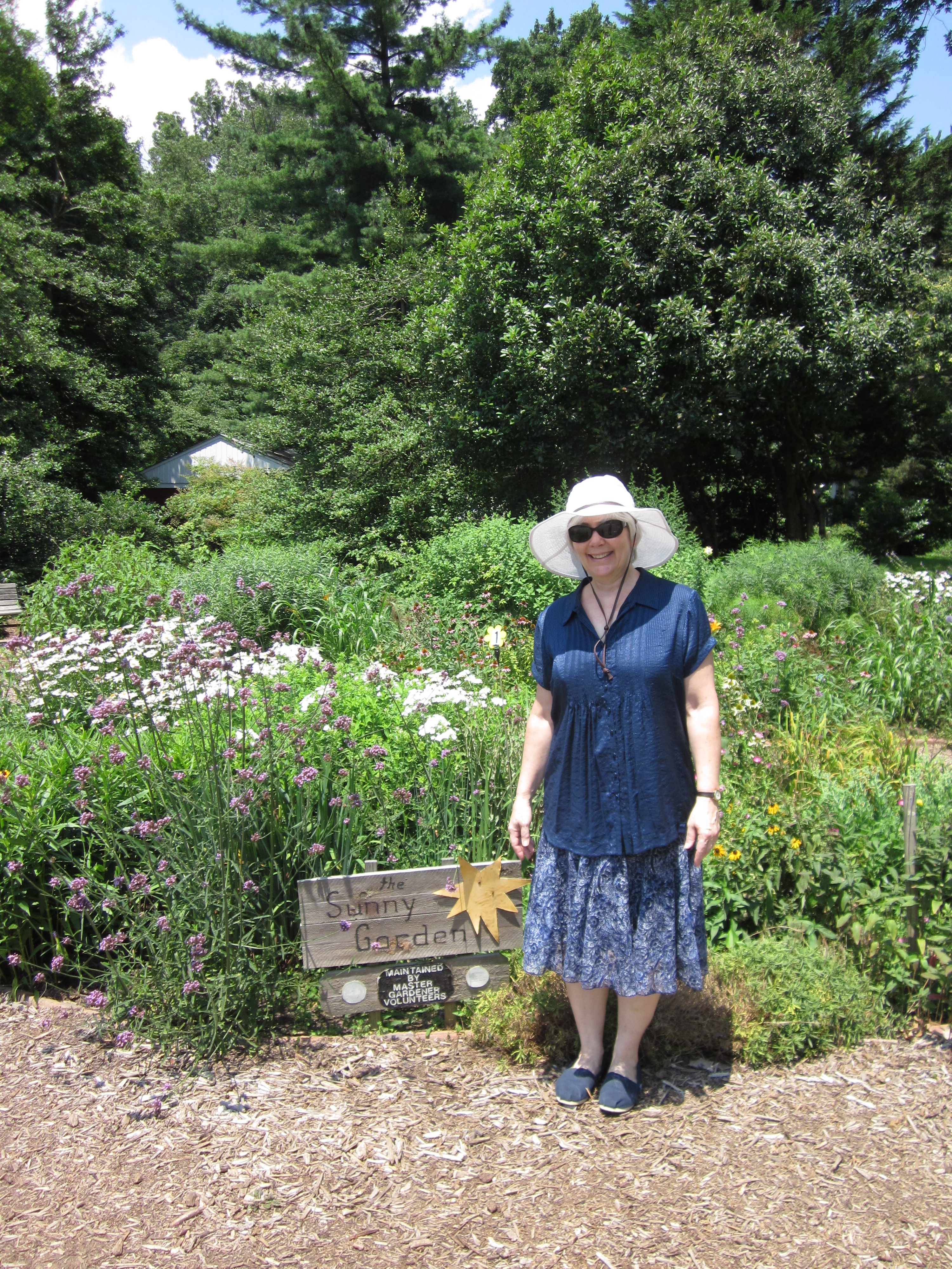 Co-coordinator Kate Donohue shows off the mid-summer blooms in Bed 1