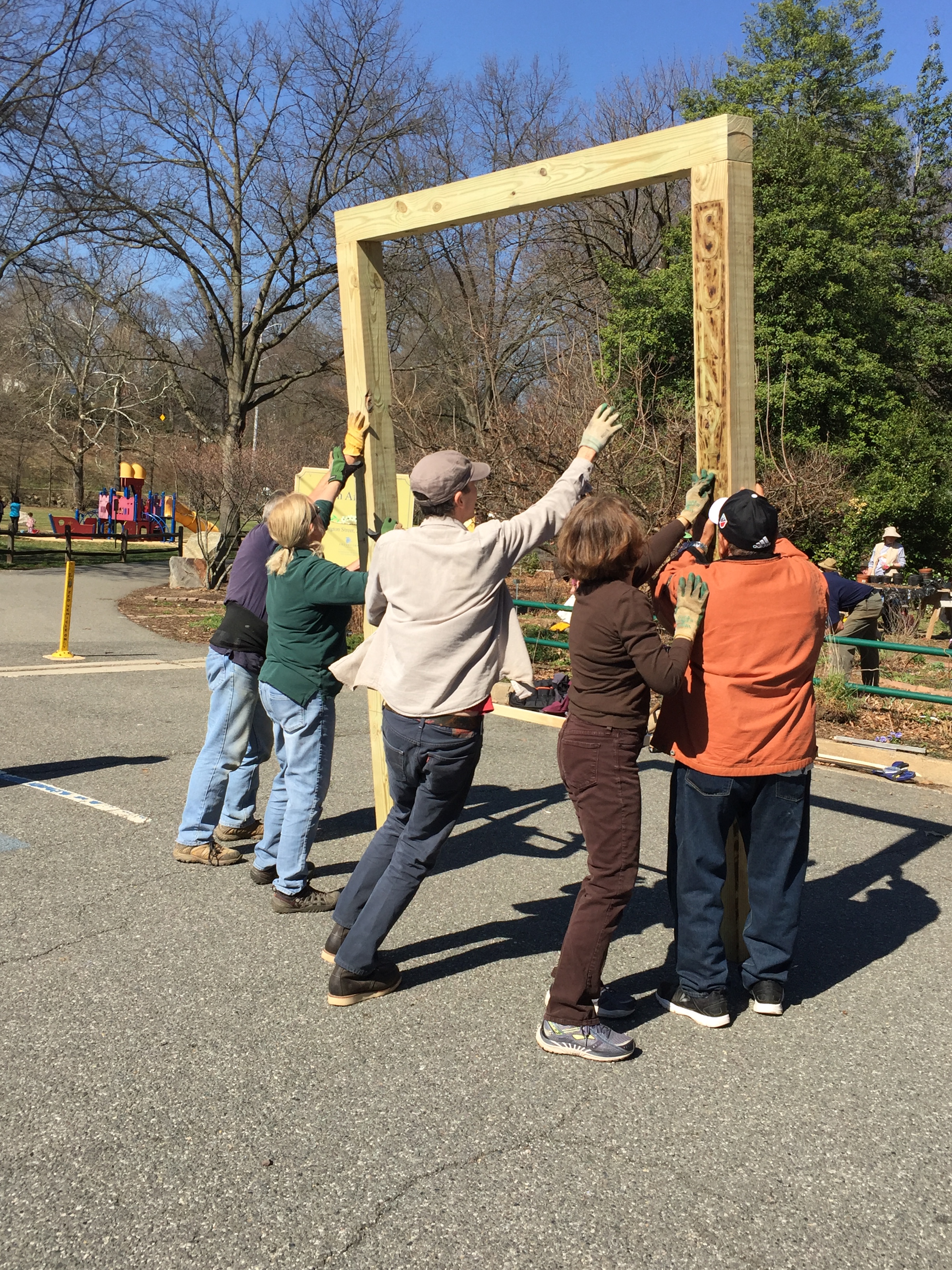 The Master Gardener crew rights the arbor.