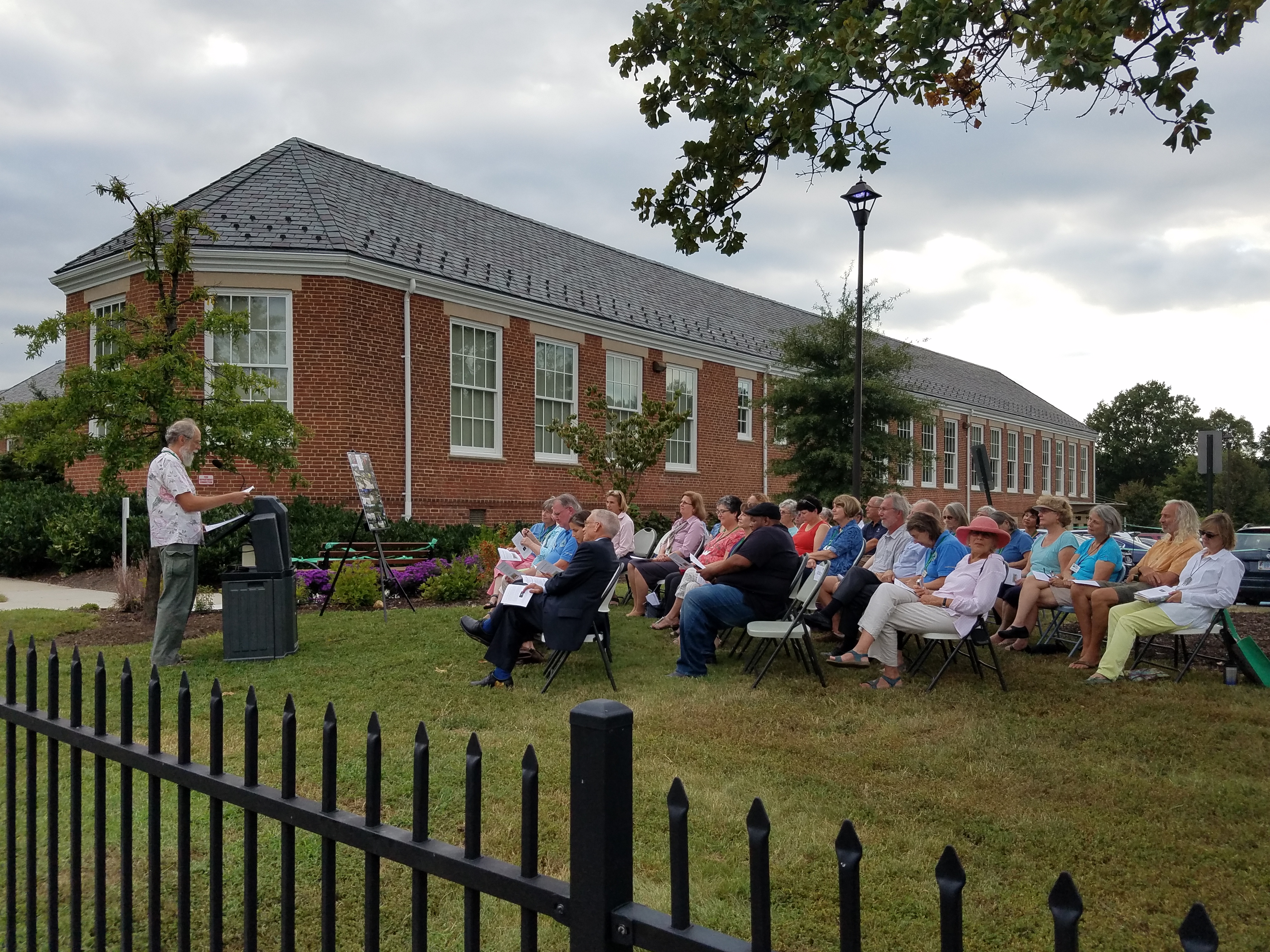 Master Gardeners and guests listening to Peter Hickmand at dedication ceremony
