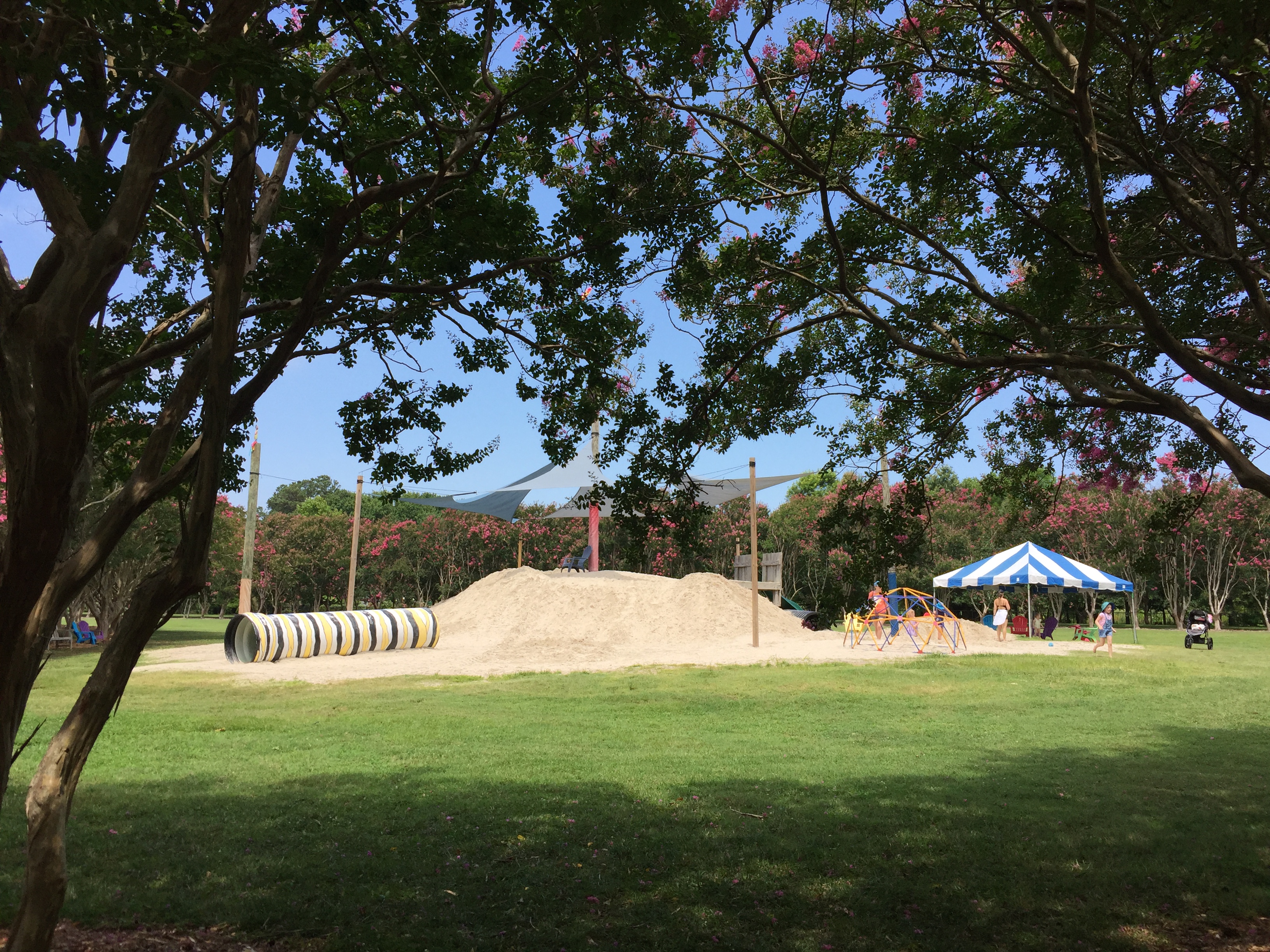 Parents can relax in nearby seating as children enjoy a sandy play area. Photo © 2018 Elaine Mills.