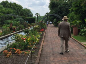 Summer plantings in the 100-yard-long Canal Garden include tropical species and plants with orange and red flowers and foliage.