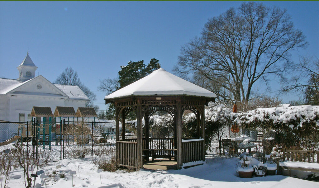 The gazebo and surrounding gardens under snow cover