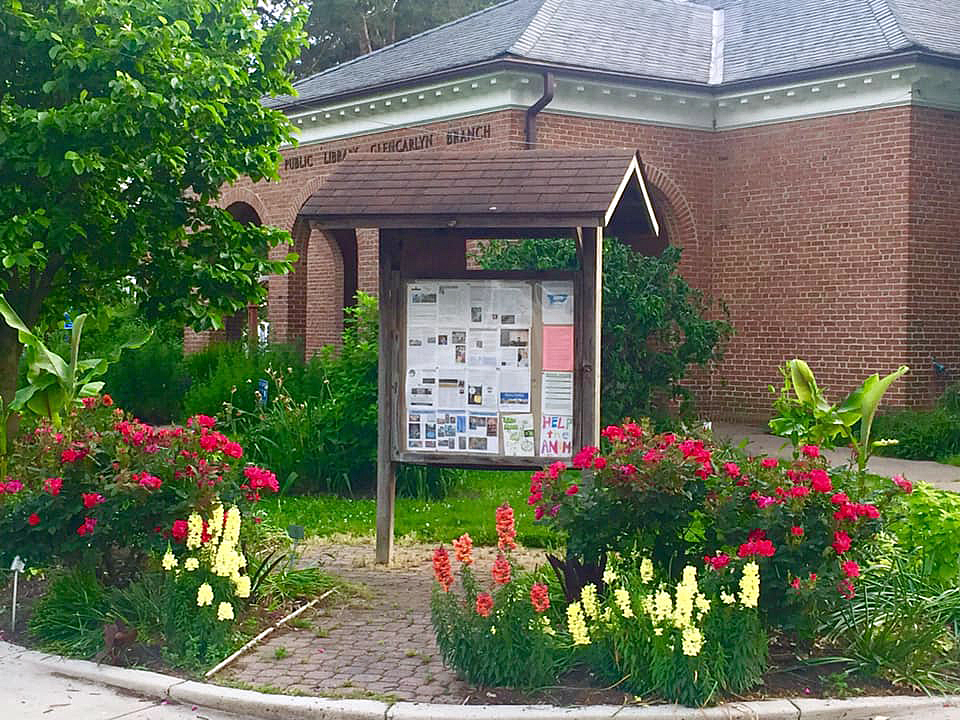 Tropical flowers in bloom in front of library building