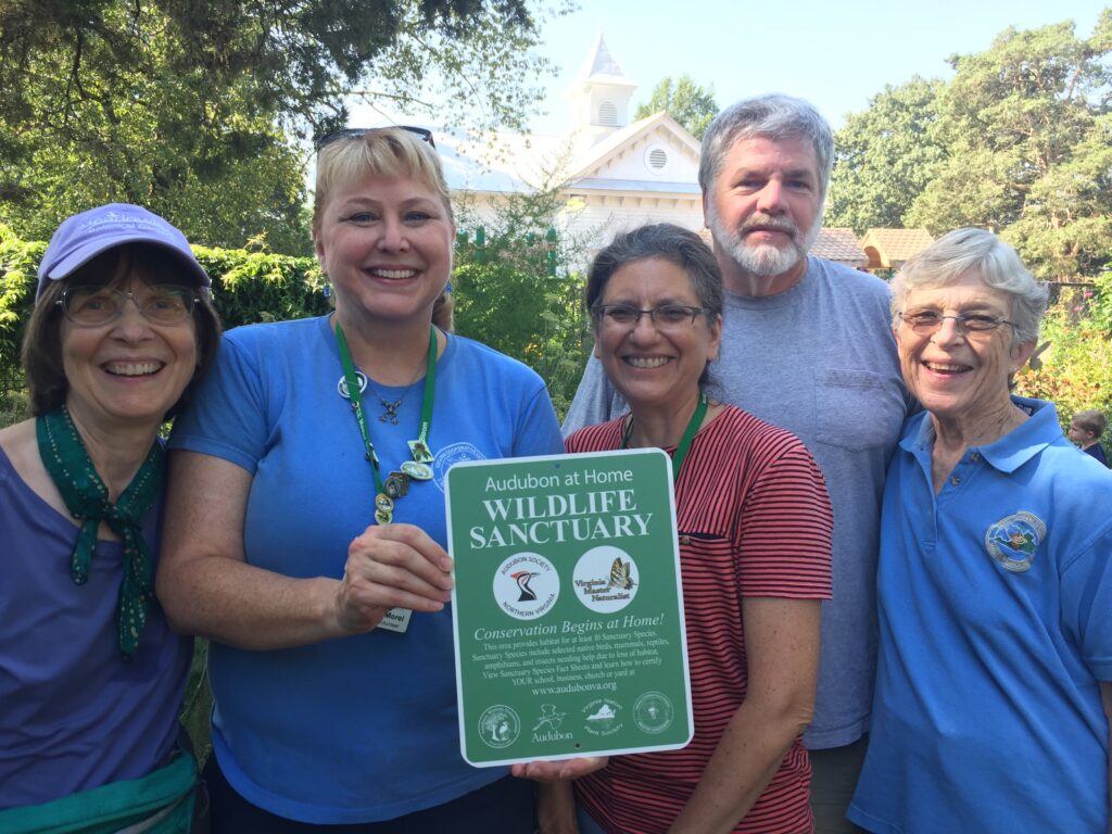 The five Glencarlyn Library Community Garden coordinators with the Audubon at Home Wildlife Sanctuary plaque.
