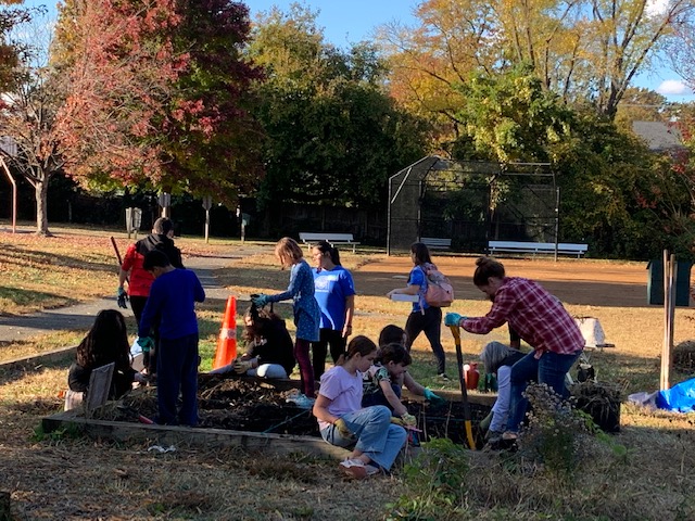 Kate Cicala, Barcroft teacher volunteer digging away with Barcroft kids