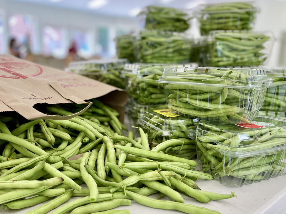 green beans in grocery bag and plastic containers