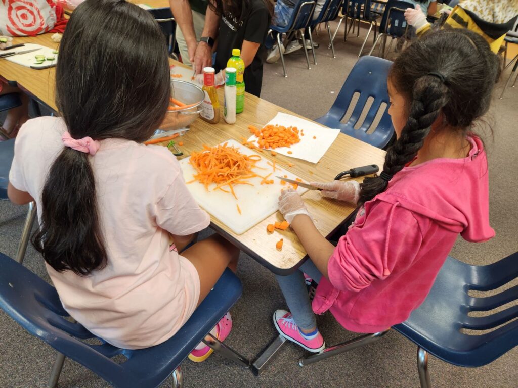 girls chopping carrots