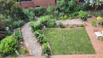 Reduced lawn, expanded planting beds, and surrounding hardscape