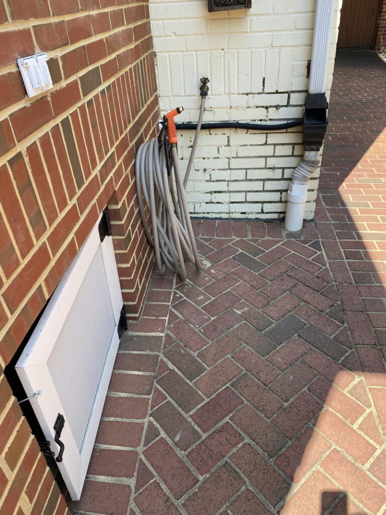Downspout on brick porch