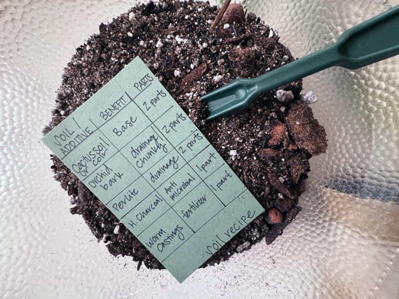 Soil mix recipe on top of soil in glass