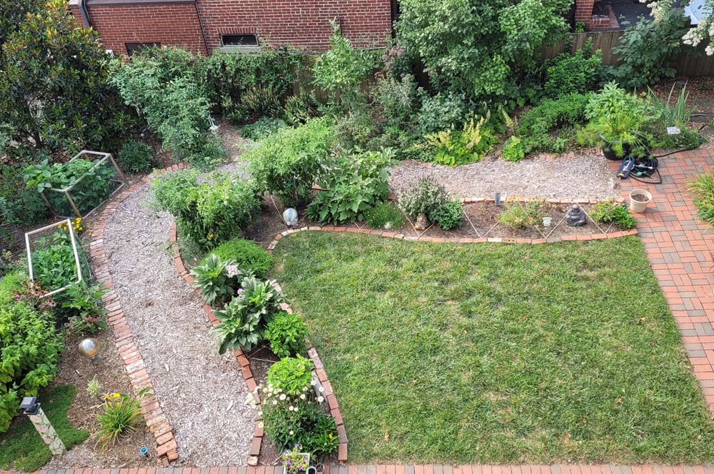 Reduced lawn, expanded planting beds, and surrounding hardscape