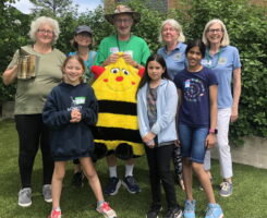 Extension Master Gardeners and children with bee costume