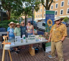 People standing around table outdoors