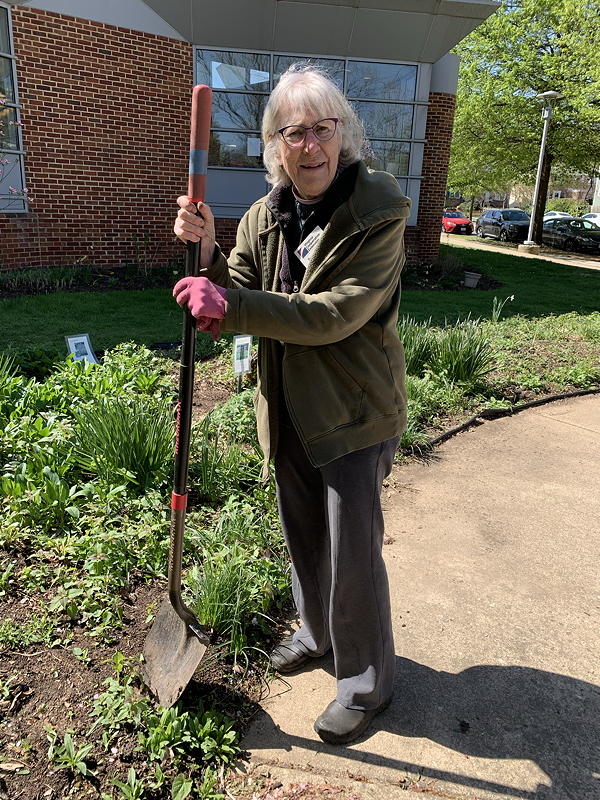 Woman standing with shovel